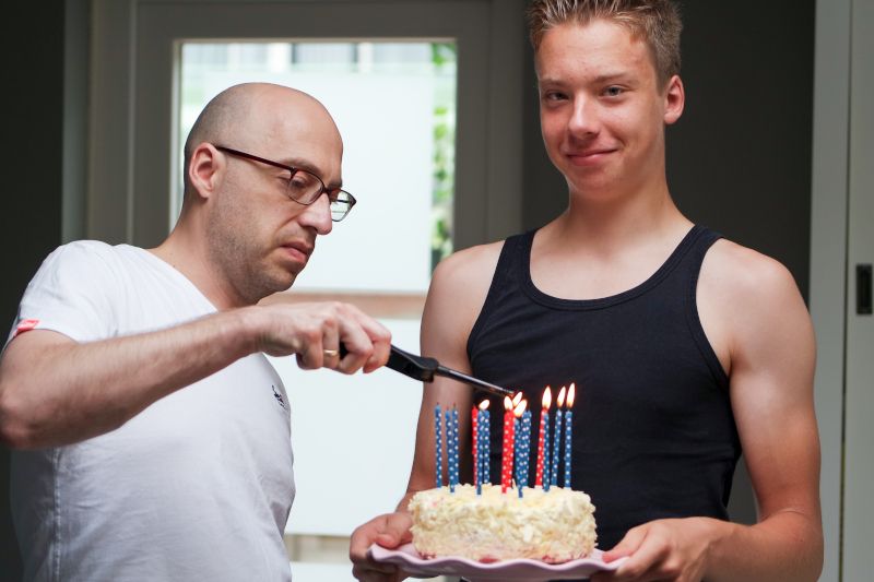 teenage-boy-holding-his-birthday-cake